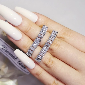 Minimalist silver bar earrings with rectangular zircon stones held in a hand