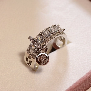 Silver-toned zircon ring with geometric hollow band and sparkling round charm pendant