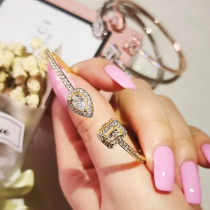 Close-up of a gold irregular cuff bracelet featuring pear and emerald cut crystals