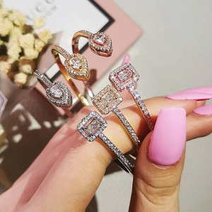 Close-up of luxury adjustable open rings with teardrop and rectangular zircons