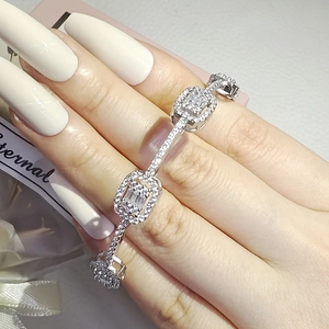 Macro detail of silver-tone irregular link bracelet with square zirconia stones