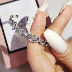 Close-up of silver open cuff bracelet with double rows of baguette-cut crystals