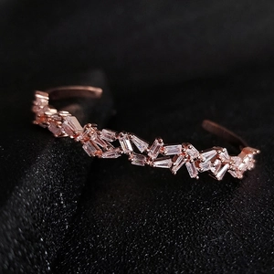 Macro shot of rose gold open cuff bracelet with irregular rectangular cubic zirconia stones