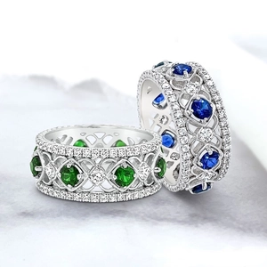 Art Deco style silver rings featuring emerald and sapphire gemstones with diamonds