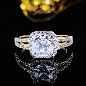 Macro detail of luxury cushion-cut halo ring with split-shank band on black mirror