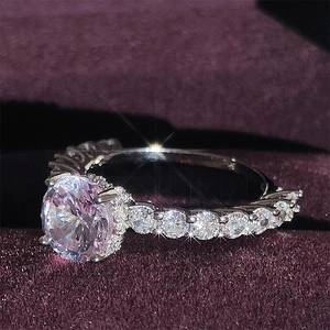Macro shot of a brilliant round-cut cubic zirconia ring on purple velvet background