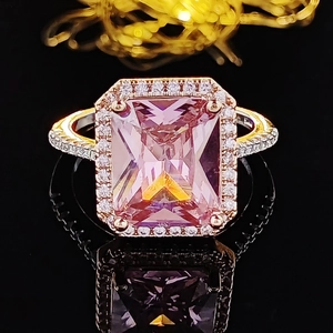 Elegant rectangle emerald cut pink sapphire ring with halo diamonds on rose gold band