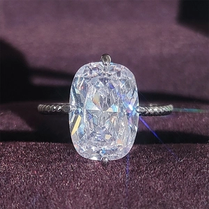 Anello di lusso con zircone a cuscino e fascia a corda su sfondo di velluto viola