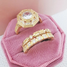 Detailed view of luxury octagon halo rings set in a pink velvet jewelry box display