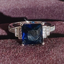 Makroaufnahme eines S925-Silberrings mit blauem Edelstein und Zirkonia-Besatz
