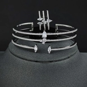 Macro shot of silver triple-row bangle and ring set with pear-shaped marquise stones