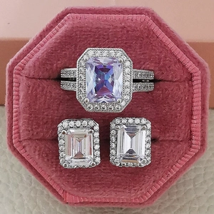 Elegant geometric jewelry set with lavender emerald-cut gemstone ring and studs in a pink box
