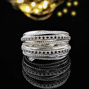 Detail of multi-layer silver ring with black crystals and twisted rope design