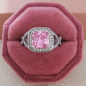 Classic silver ring with large pink cushion-cut gemstone and pavé diamonds in velvet box