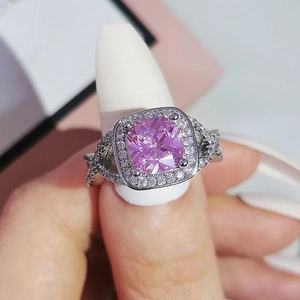 Elegant silver ring with cushion-cut pink gemstone and pavé diamonds on a model hand