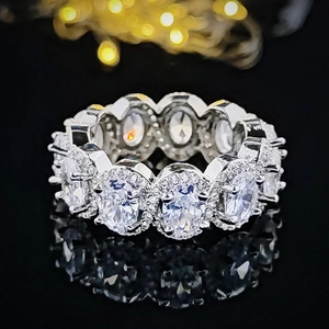 Luxury oval cut cubic zirconia eternity ring in silver halo setting with black reflection