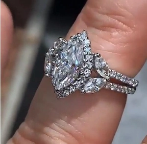 Close-up of a marquise cut cubic zirconia ring with clustered halo and side stone detail