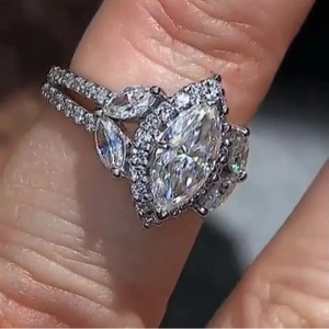 Marquise cut zircon ring with halo setting and leaf design on polished silver band