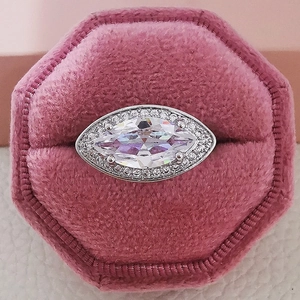 Elegant marquise cut halo engagement ring in silver finish presented in a velvet box