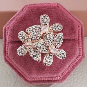 Lujoso anillo con forma de flor en oro rosa con circonitas blancas en caja de terciopelo