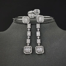 Detailed macro view of vintage square zircon pendant necklace and stud earrings set