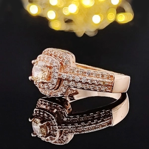 Luxurious 14k rose gold ring with a large halo-set round gemstone and micro-pave diamonds