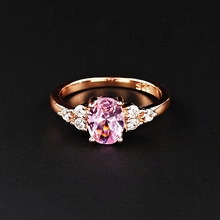 Detailed close-up of S925 rose gold ring with oval pink stone and brilliant diamonds