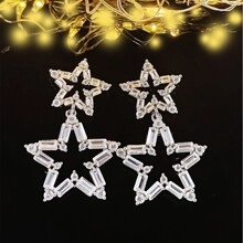 Macro shot of silver star-shaped earrings encrusted with sparkling cubic zirconia crystals