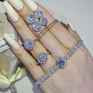 Blue sapphire halo jewelry set including necklace, earrings, ring and tennis bracelet