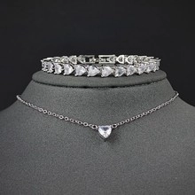 Detail view of silver zircon heart pendant necklace and matching tennis bracelet set