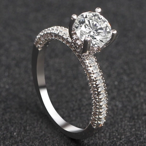 Elegant silver round brilliant cut moissanite engagement ring with micro-pave diamond band