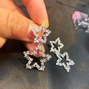 Detail of silver double star drop earrings with sparkling cubic zirconia pavé stones