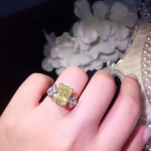 Luxury silver ring featuring a large rectangular yellow stone and sparkling side zircons