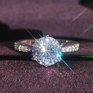 Classic six-prong zircon ring with pave band presented in a purple velvet jewelry box