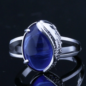 Exquisite angel wing ring featuring a large oval blue gemstone on a split silver band