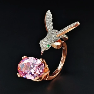 Rose gold hummingbird ring with large oval pink gemstone and white pavé crystals
