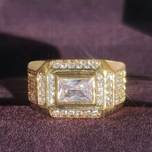 Macro shot of gold-plated ring with emerald-cut zirconia and pave side stones