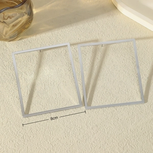 Minimalist silver geometric square hoop earrings with large 8cm frame in 45-degree view