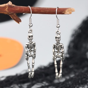 Boucles d'oreilles gothiques en forme de crâne argenté suspendues sur des branches