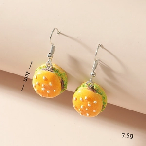 Macro detail of cute resin hamburger earrings showing 2cm height and realistic food texture