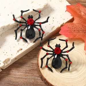 Detail of gothic spider earrings with red rhinestones and black gems for Halloween style