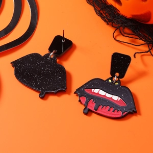 Macro detail of acrylic vampire lips earrings with dripping blood for Halloween party