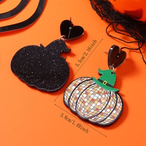 Detail of acrylic Halloween earrings featuring a disco pumpkin and green witch hat
