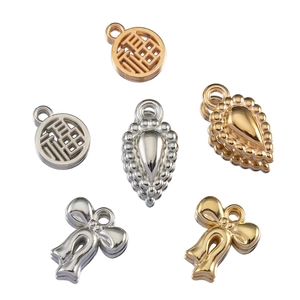 Close-up of golden and silver CCB charms including bowknot, teardrop, and round Fuzhi pendants