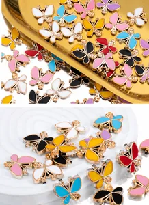 Detailed macro view of colorful butterfly charms with gold metal frames for DIY jewelry