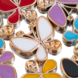 Macro shot of colorful enamel butterfly charms with metallic edges for DIY jewelry making