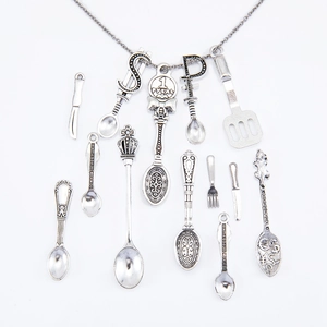 Macro shot of vintage alloy kitchen utensil pendants including spoons with coin symbols