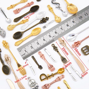 DIY vintage alloy cutlery pendants in various metallic finishes with measuring ruler
