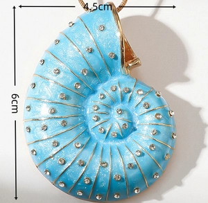 Macro shot of 6cm blue conch pendant with gold texture and inlaid rhinestones