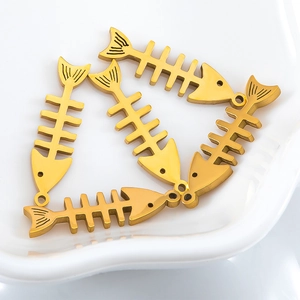Detailed view of golden stainless steel fishbone charms for DIY jewelry making and crafts
